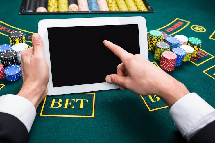 garasibet app running on Android smartphone showing slot game interface and live-dealer table lobby